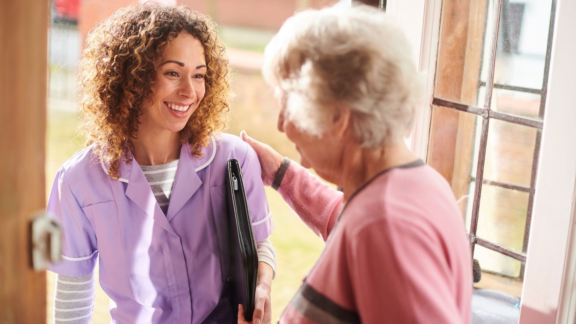 Caregiving is a Career for Everyone : Young women talking to her client 