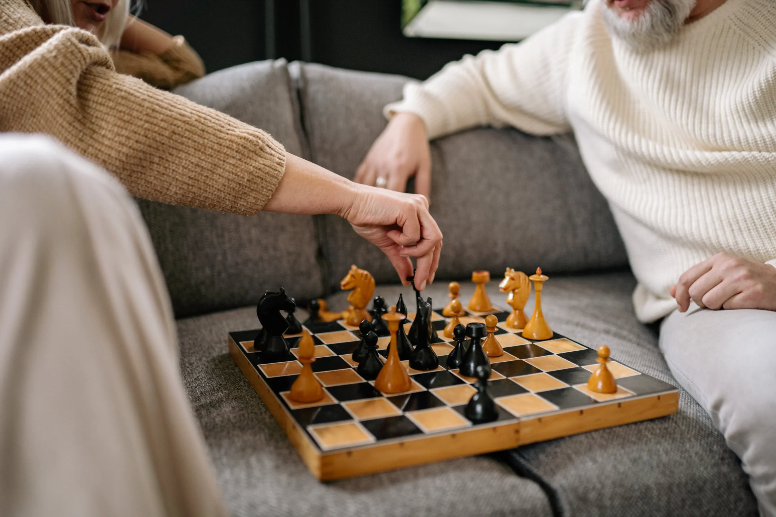 Two elderly people playing chess